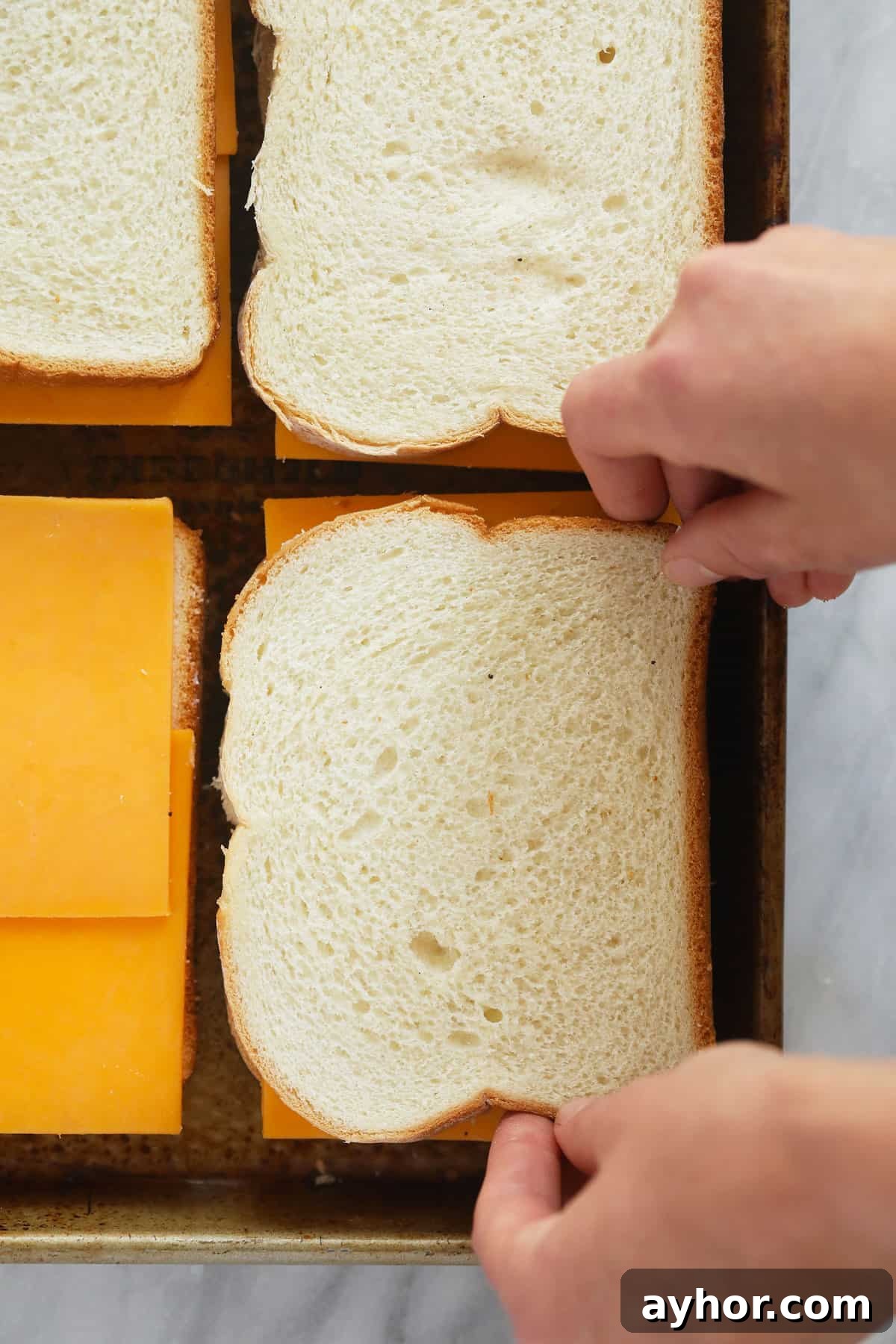 Sandwiches on a baking sheet sheet pan grilled cheese sandwiches assembled on a baking sheet