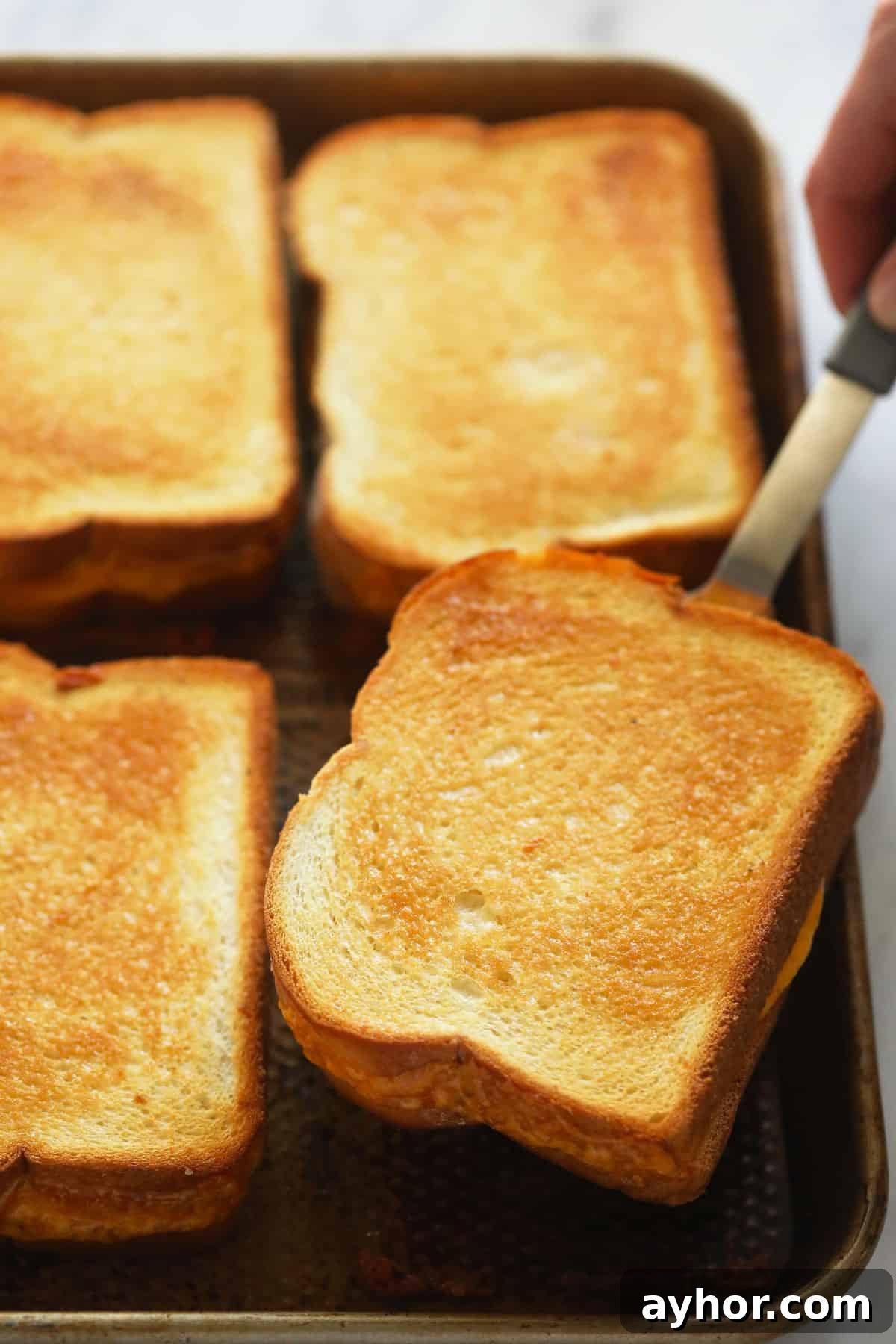 Golden-brown grilled cheese sheet pan grilled cheese sandwiches baked to golden brown perfection