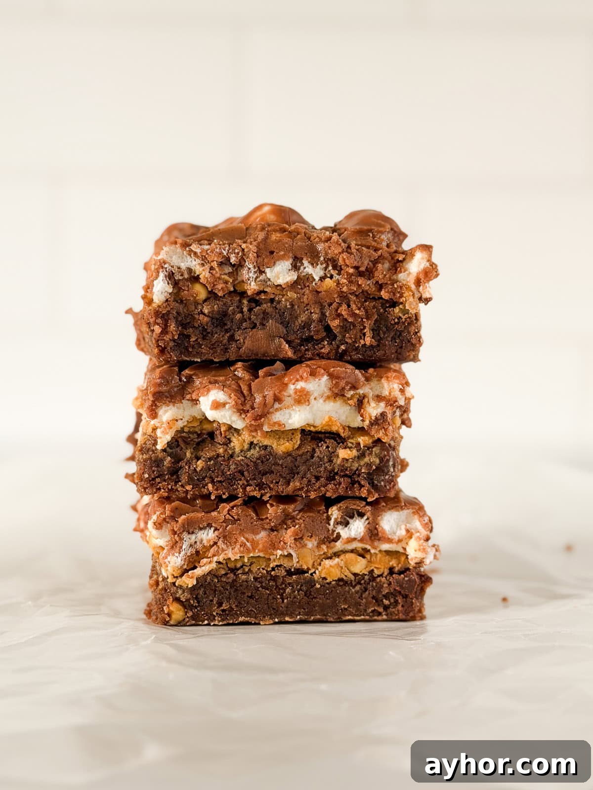 a few peanut butter marshmallow brownies stacked on top of each other.