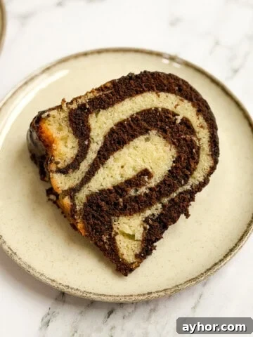 a single slice of marble bundt cake on a plate so you can see all the marbling.