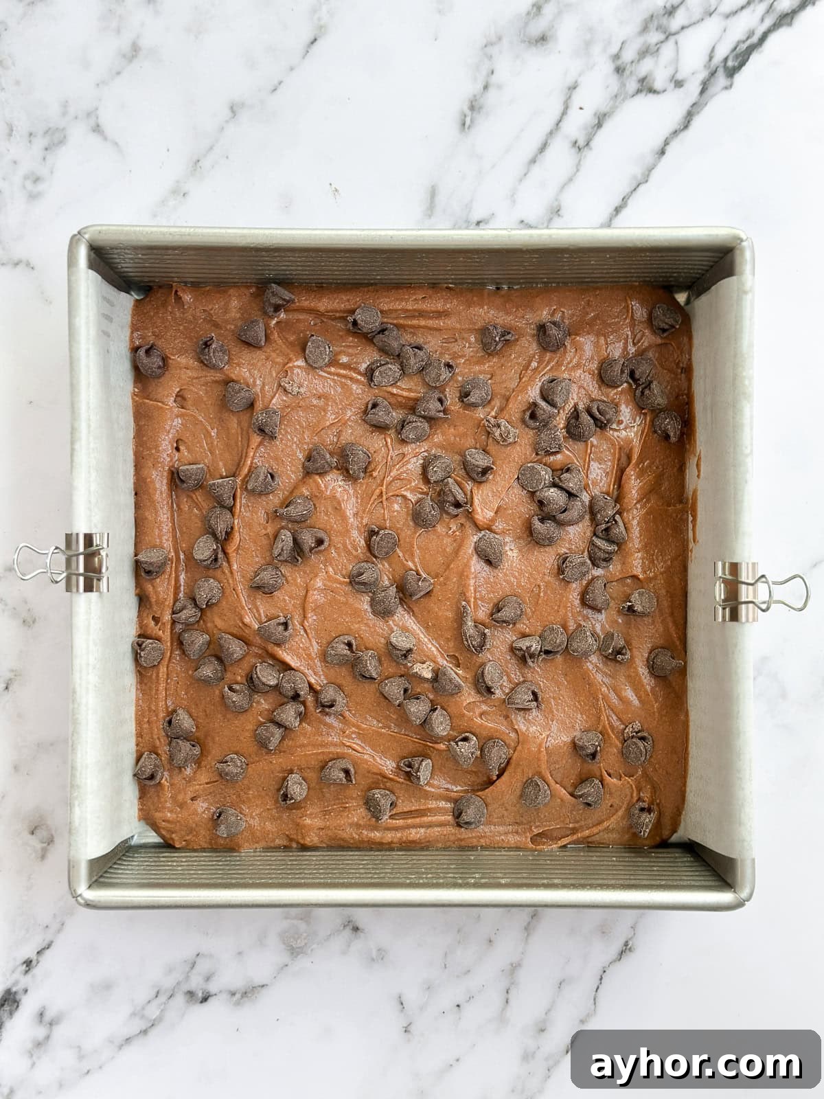 brownie batter added and chocolate chips topped.