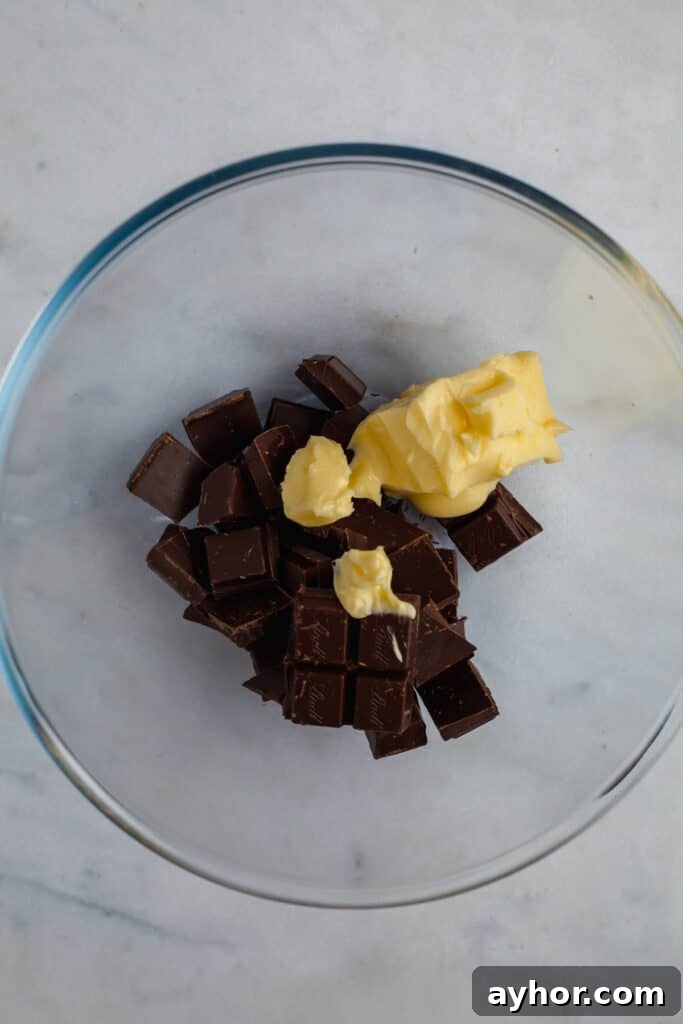 Decadent Chocolate Brownie Pie Recipe 12 Glass bowl with chopped chocolate and butter