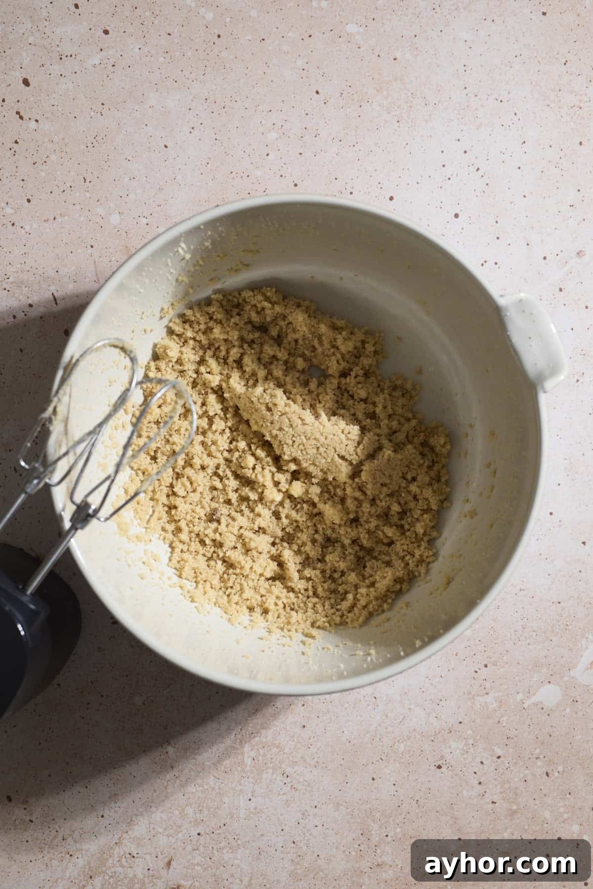 Butter and sugars creamed together in a mixing bowl.