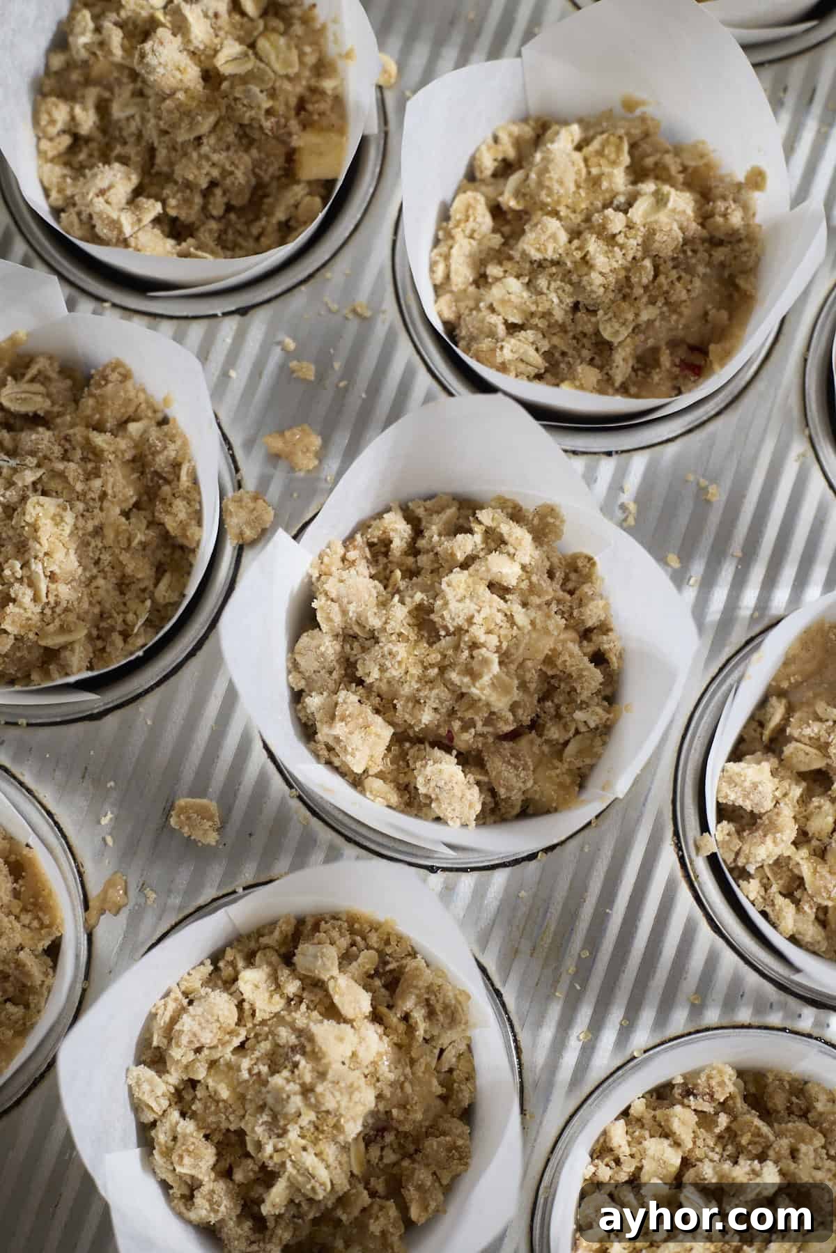 Muffins with streusel topping in the baking pan.